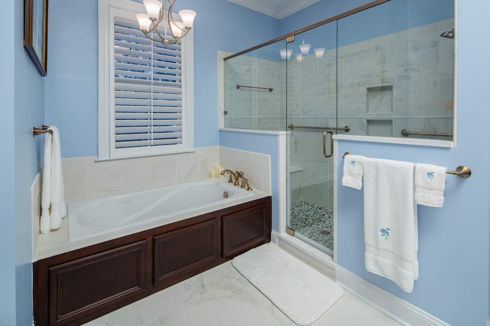 Mid-sized traditional master wet room bathroom in Atlanta with shaker cabinets, dark wood cabinets, an alcove tub, a two-piece toilet, blue walls, porcelain floors, an undermount sink and engineered quartz benchtops.