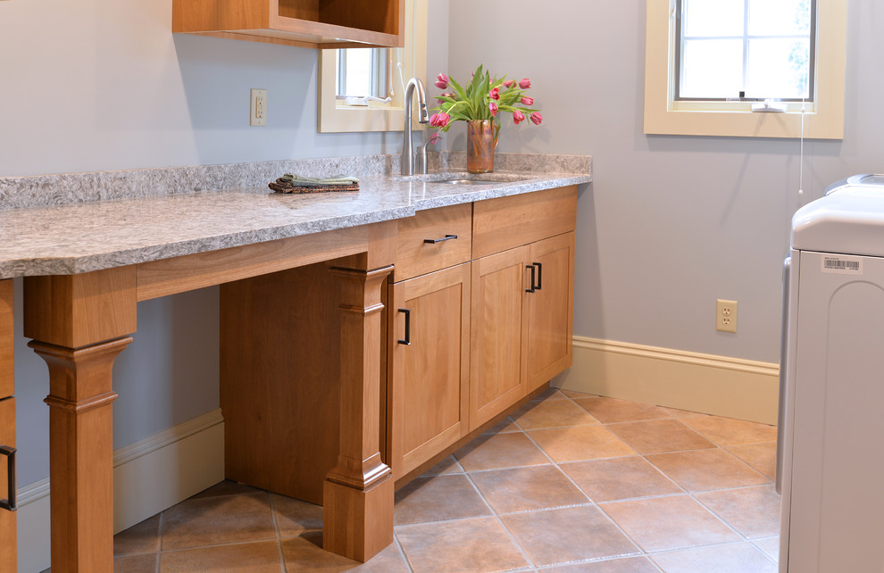 Inspiration for a transitional laundry room in New York with flat-panel cabinets and ceramic floors.