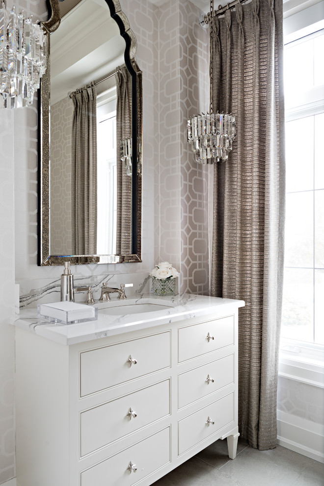 Design ideas for a mid-sized traditional powder room in Toronto with an undermount sink, furniture-like cabinets, white cabinets, beige walls, ceramic floors, engineered quartz benchtops, beige floor and multi-coloured benchtops.