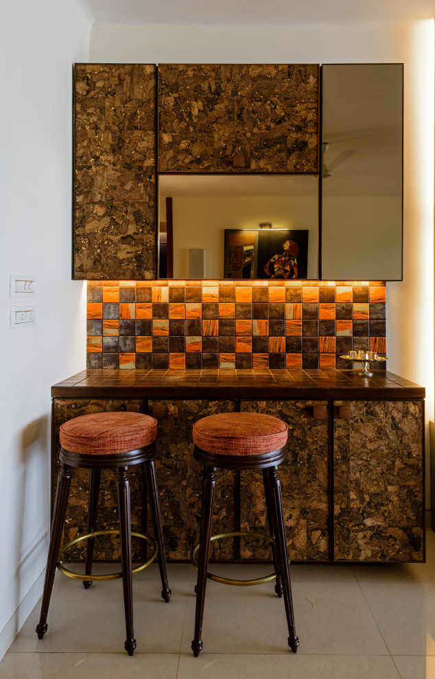 Mid-sized contemporary single-wall seated home bar in Mumbai with flat-panel cabinets, brown cabinets, multi-coloured splashback, grey floor and brown benchtop.