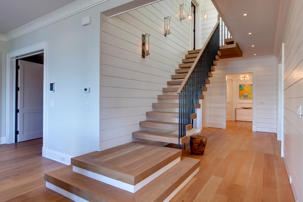 Inspiration for a large beach style wood floating staircase in Other with open risers and mixed railing.