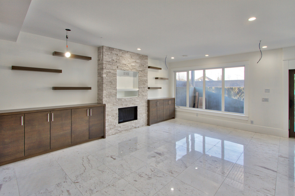 Photo of a large modern enclosed family room in Calgary with a home bar, white walls, medium hardwood floors, a standard fireplace, a stone fireplace surround and a wall-mounted tv.