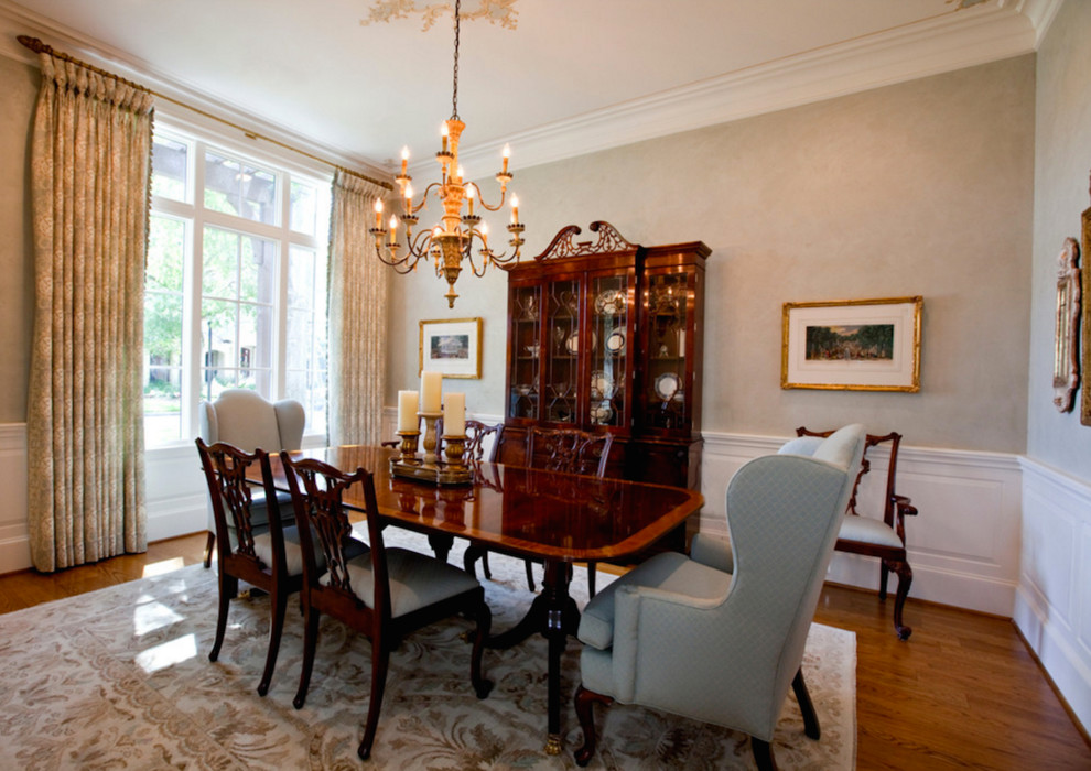 This is an example of a mid-sized traditional separate dining room in Houston with grey walls, dark hardwood floors, no fireplace and brown floor.