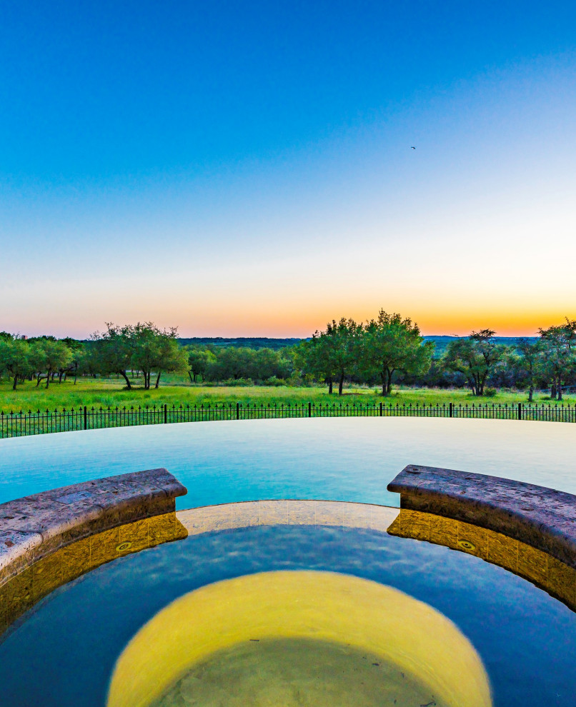 This is an example of a mediterranean pool in Austin with a hot tub.