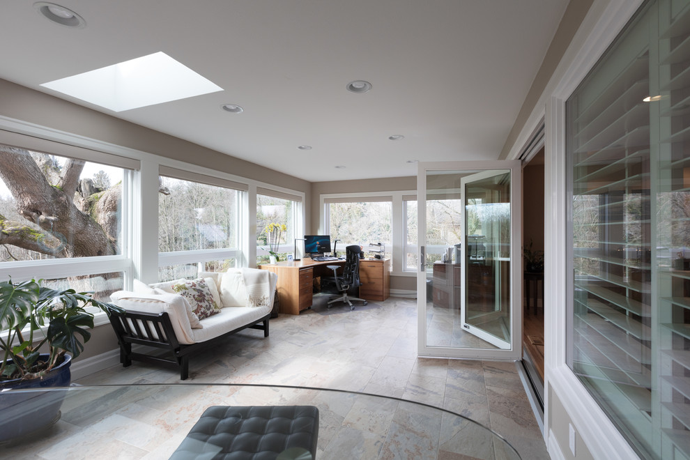 Design ideas for a mid-sized transitional sunroom in Seattle with porcelain floors, no fireplace, a skylight and beige floor.