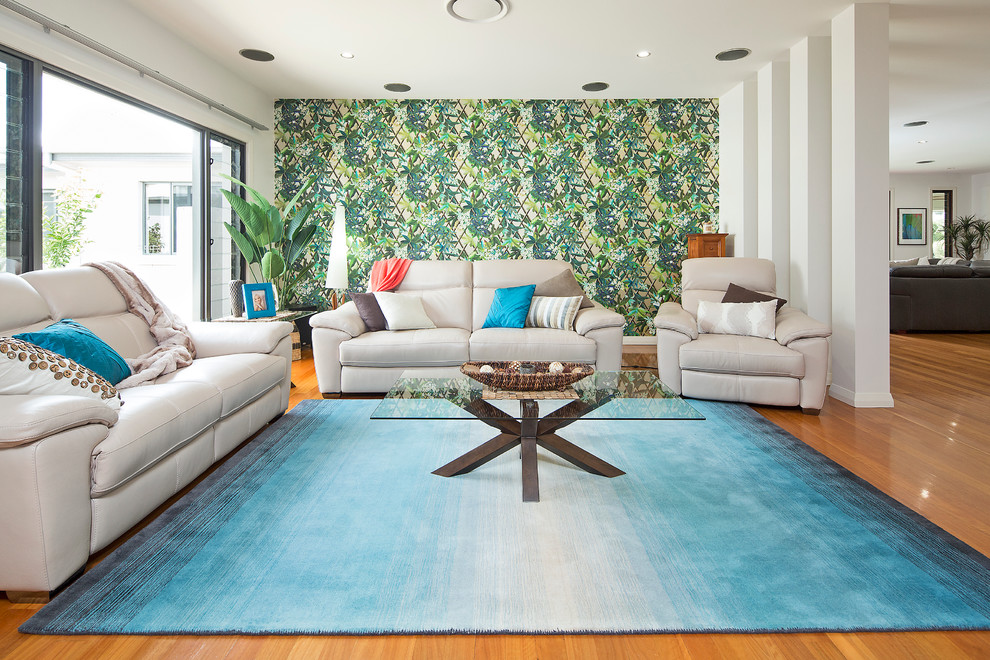 Photo of a large tropical open concept family room in Gold Coast - Tweed with medium hardwood floors and green walls.