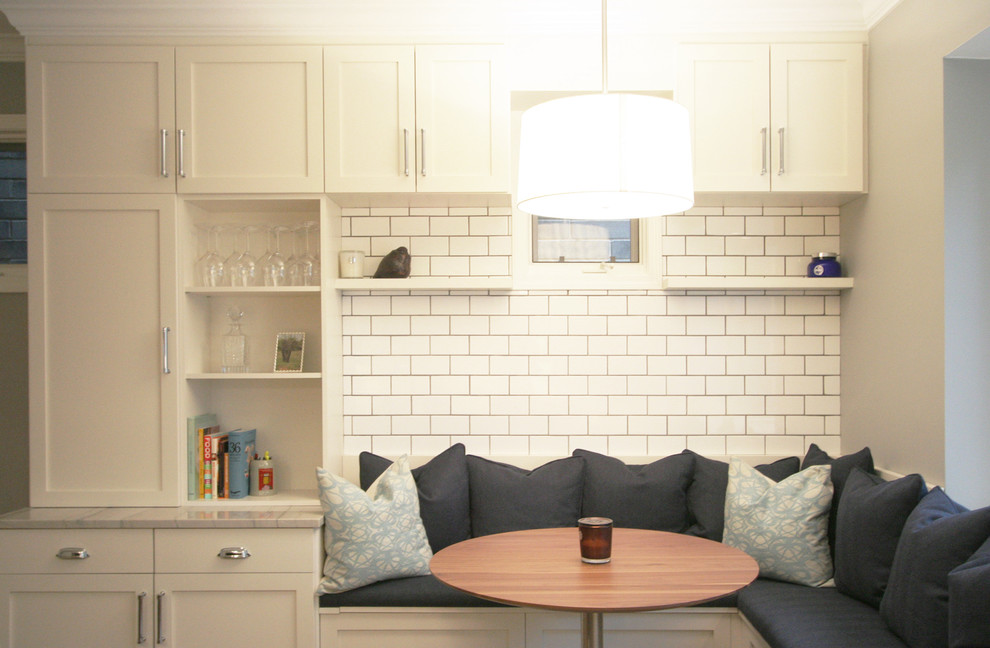 Kitchen - large transitional medium tone wood floor kitchen idea in Chicago with an undermount sink, shaker cabinets, white cabinets, quartzite countertops, white backsplash, subway tile backsplash, stainless steel appliances and an island
