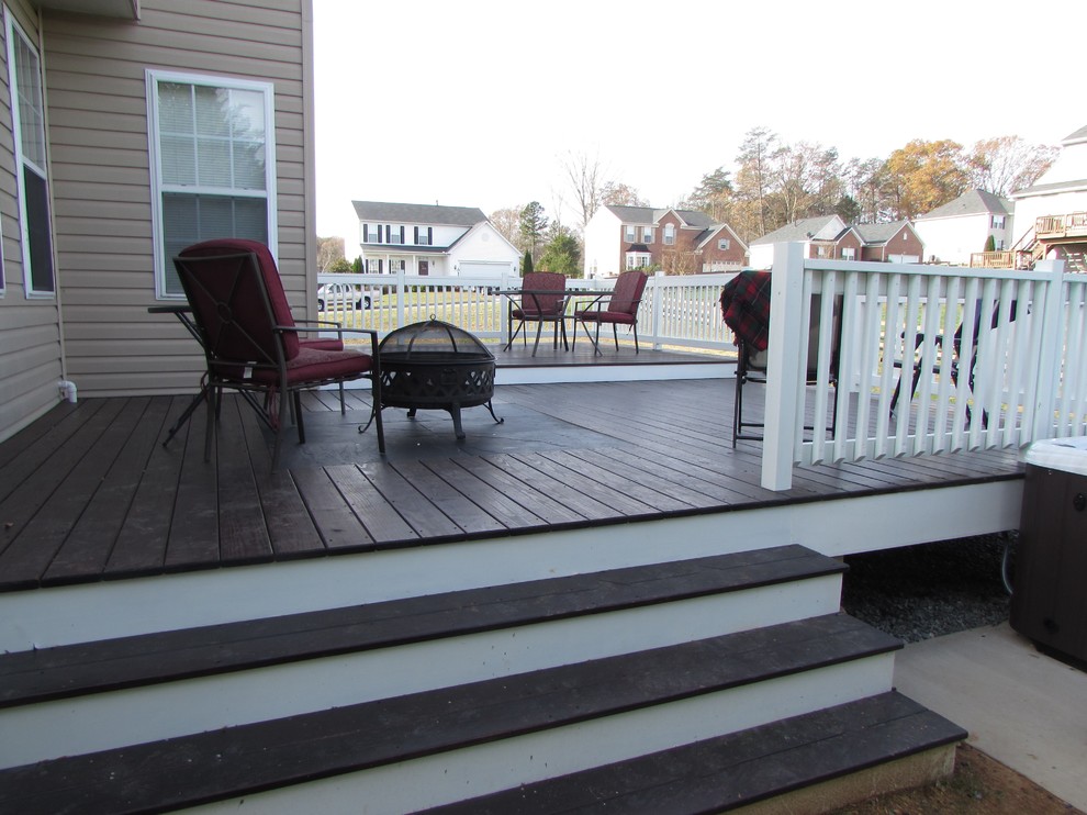 Inspiration for a large transitional backyard deck remodel with a fire pit and no cover