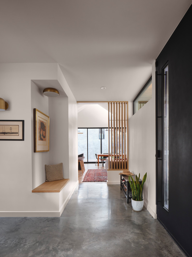 Entryway - contemporary concrete floor and gray floor entryway idea in Austin with a metal front door