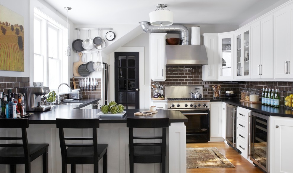 Inspiration for a traditional u-shaped eat-in kitchen in San Francisco with shaker cabinets, subway tile splashback, brown splashback, white cabinets, an undermount sink, stainless steel appliances and black benchtop.