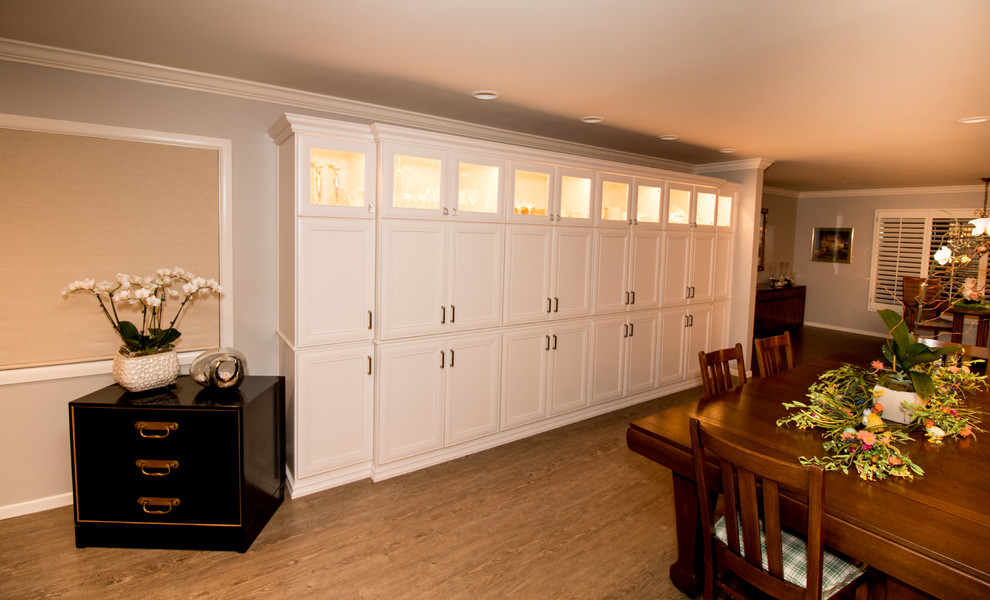 Open concept kitchen - huge transitional open concept kitchen idea with a farmhouse sink, recessed-panel cabinets, white cabinets, quartz countertops, beige backsplash, stone tile backsplash, stainless steel appliances and an island