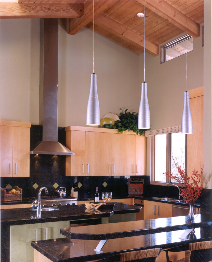 Inspiration for an u-shaped eat-in kitchen remodel in San Diego with an undermount sink, flat-panel cabinets, light wood cabinets, granite countertops, black backsplash, stainless steel appliances and an island
