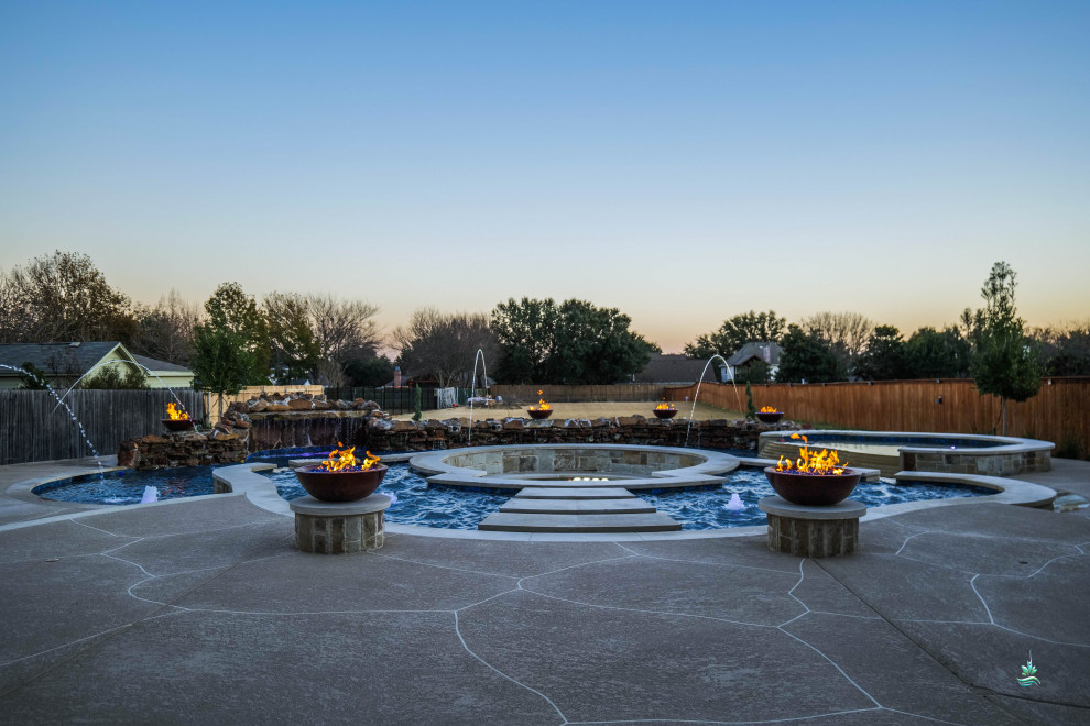 This is an example of an expansive country backyard custom-shaped natural pool in Dallas with with a pool and concrete pavers.