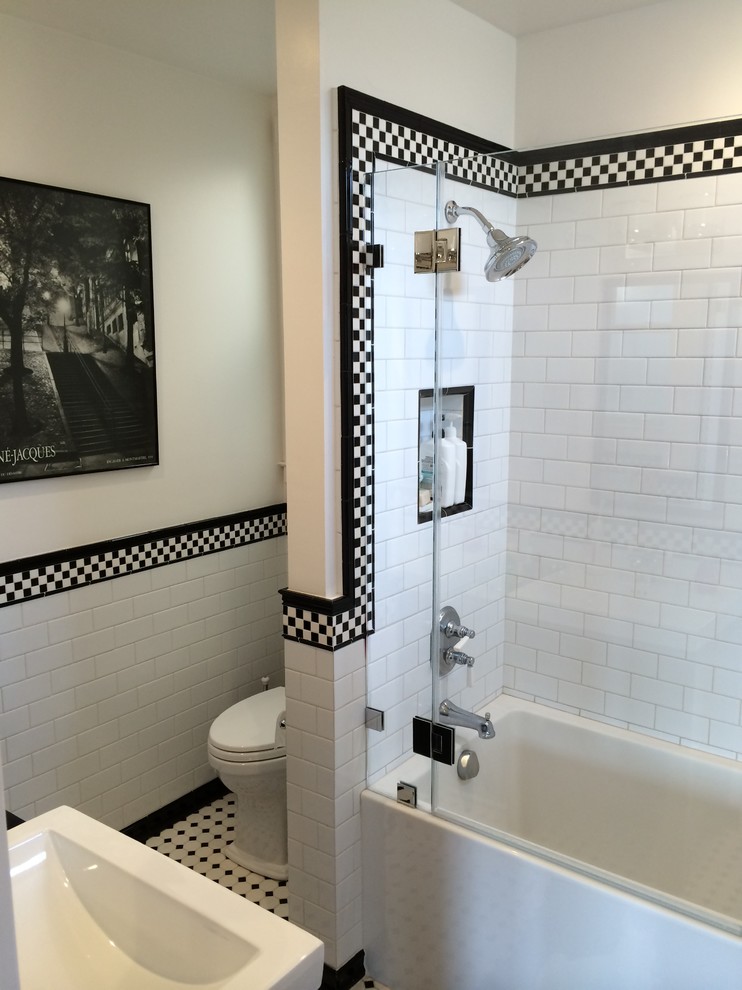 Photo of a traditional master bathroom in San Francisco with an alcove tub, black and white tile, subway tile, porcelain floors and a console sink.