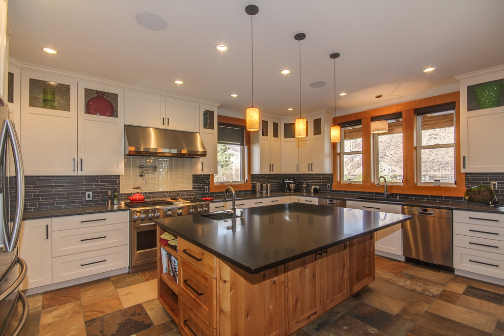 Traditional kitchen in Seattle with glass-front cabinets and stainless steel appliances.