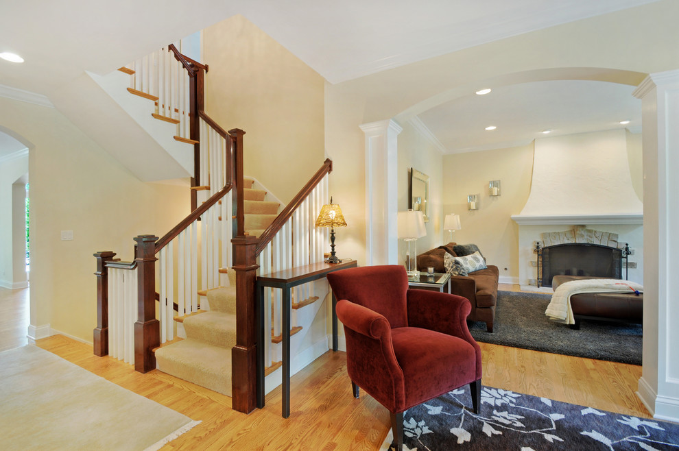 Mid-sized traditional wood u-shaped staircase in Chicago with painted wood risers.