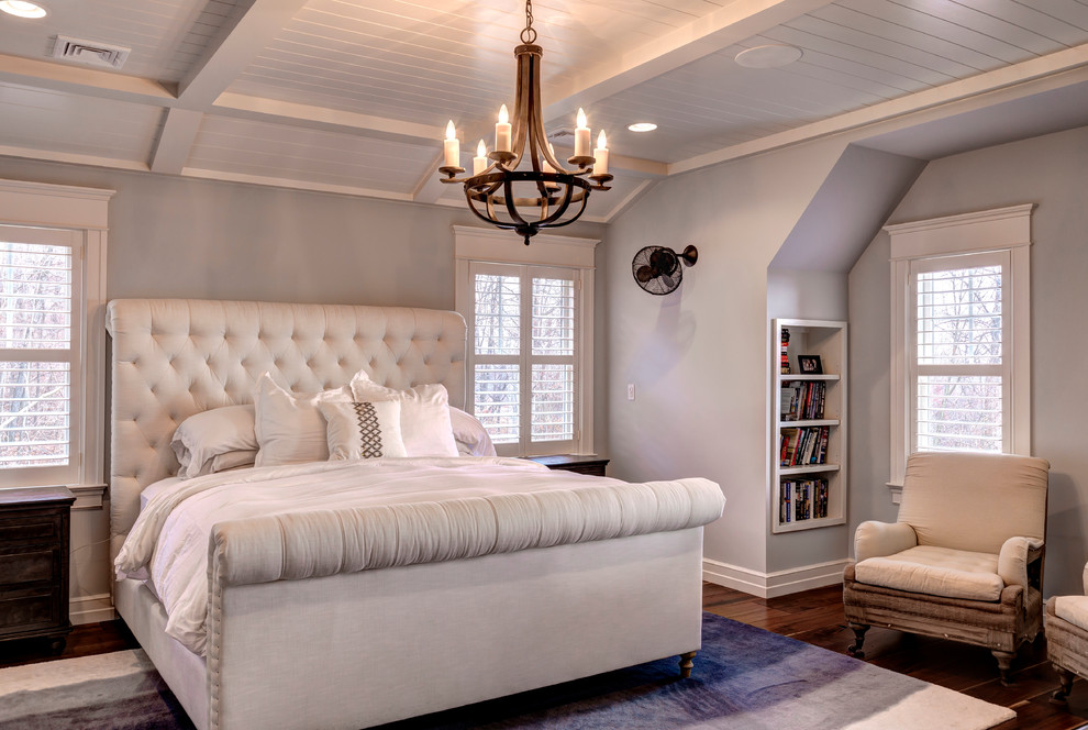 This is an example of a country bedroom in Other with grey walls and dark hardwood floors.