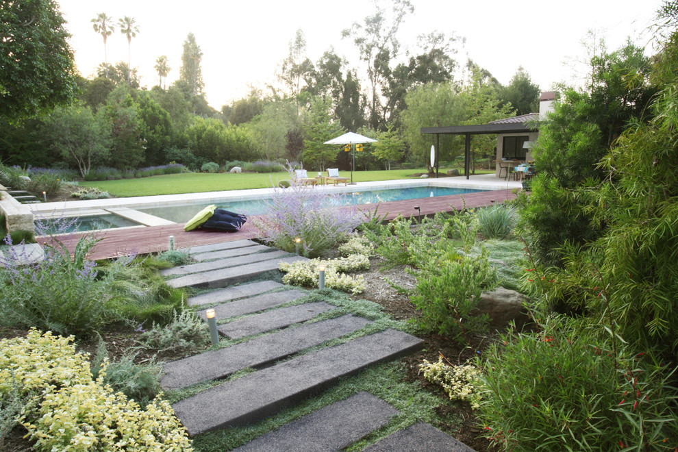 This is an example of an expansive contemporary backyard partial sun garden in Los Angeles.