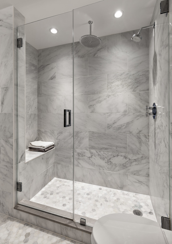 Photo of a transitional bathroom in New York with an alcove shower, gray tile, white tile, grey walls, mosaic tile floors and a hinged shower door.