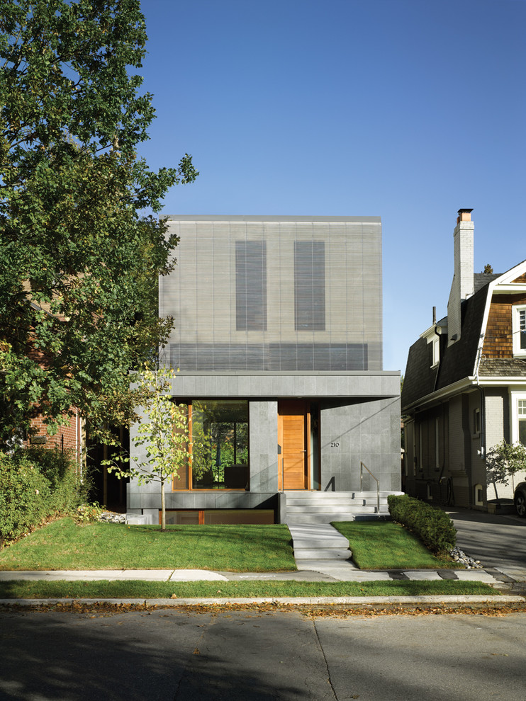 Design ideas for a modern two-storey grey exterior in Toronto with a flat roof.
