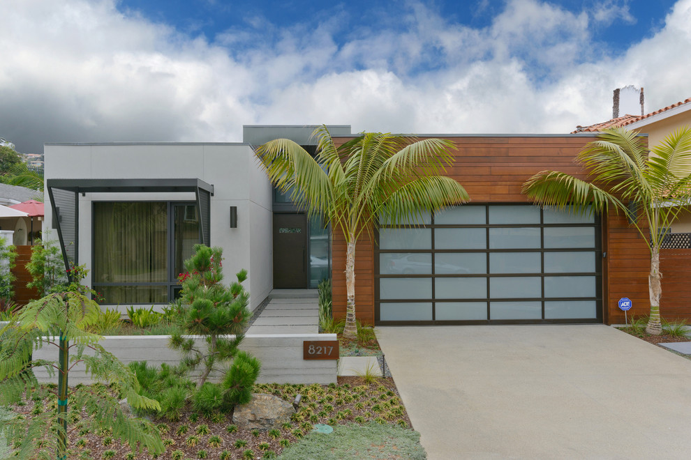 Photo of a large midcentury one-storey grey exterior in San Diego with mixed siding.