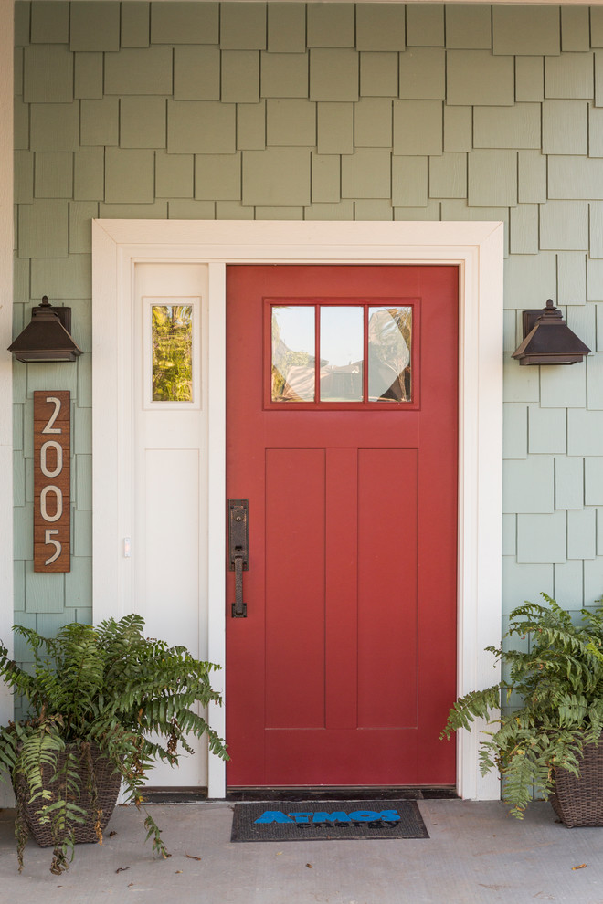 This is an example of a large arts and crafts front door in Austin with a single front door and a red front door.