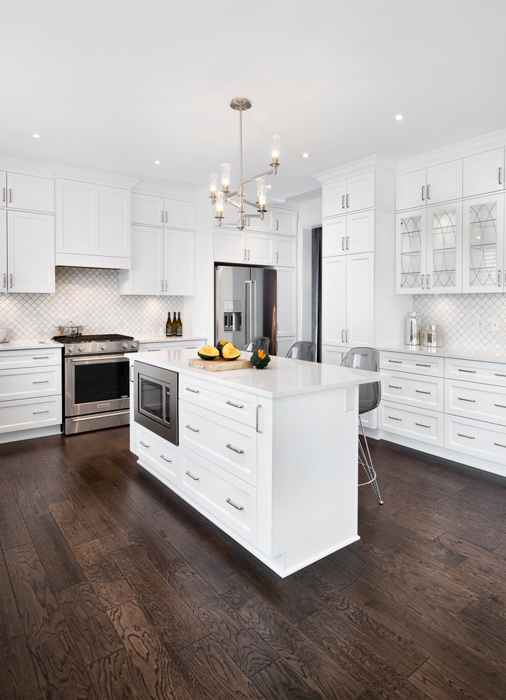 Large u-shaped separate kitchen in Ottawa with an undermount sink, recessed-panel cabinets, white cabinets, granite benchtops, white splashback, mosaic tile splashback, stainless steel appliances, dark hardwood floors and with island.