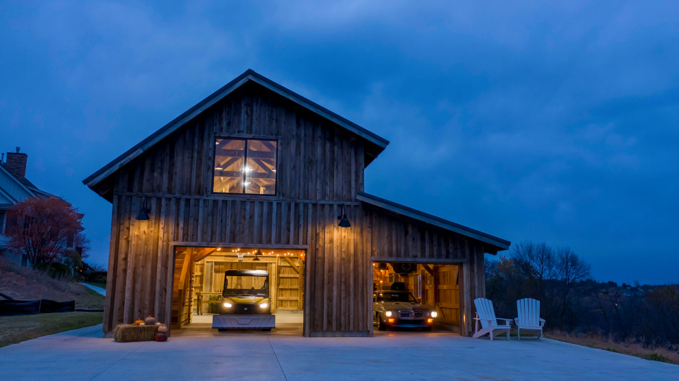 Idée de décoration pour un grand garage pour deux voitures séparé chalet avec un bureau, studio ou atelier.