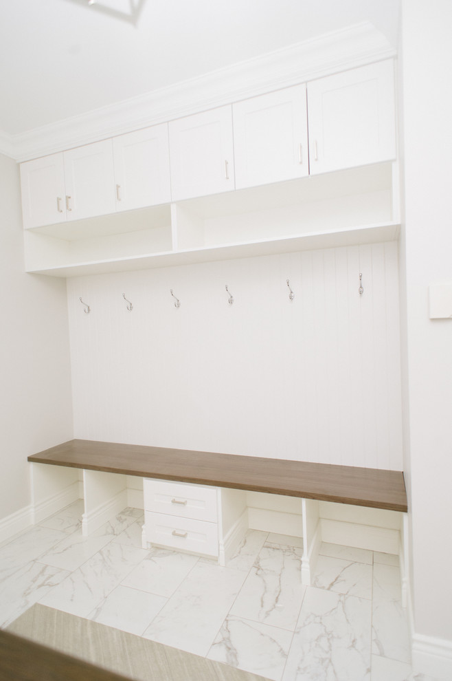 Inspiration for a transitional porcelain tile mudroom remodel in Toronto