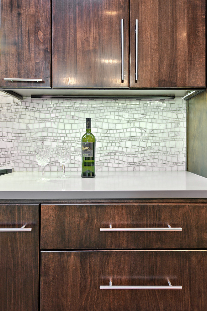 Open concept kitchen - mid-sized contemporary galley open concept kitchen idea in Austin with flat-panel cabinets, medium tone wood cabinets, stainless steel appliances, quartz countertops and gray backsplash