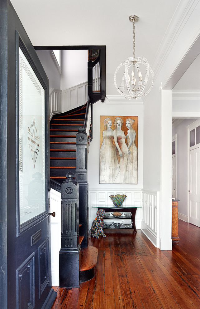 Photo of a transitional entryway in Charleston with white walls, medium hardwood floors, a glass front door, a single front door and brown floor.