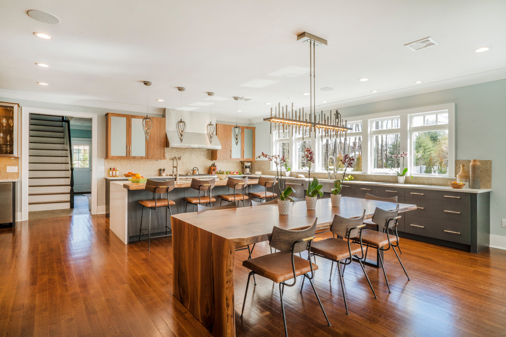Inspiration for a large transitional eat-in kitchen remodel in New York with medium tone wood cabinets, quartzite countertops, metallic backsplash, metal backsplash, stainless steel appliances, an island, white countertops and flat-panel cabinets
