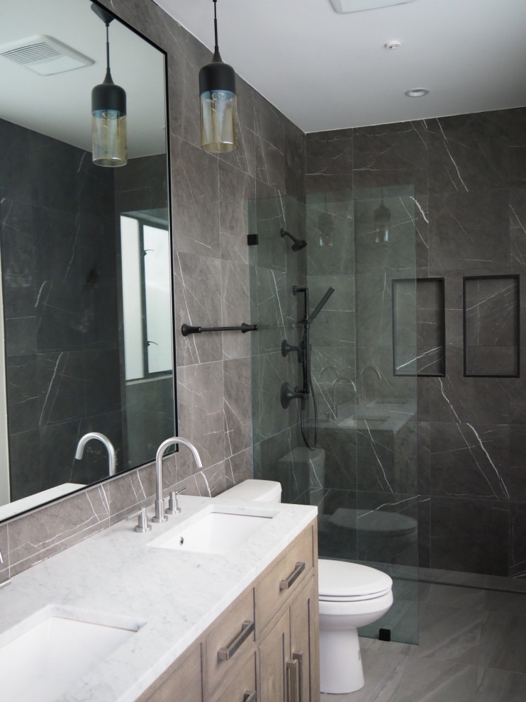 Photo of a mid-sized modern bathroom in Los Angeles with recessed-panel cabinets, white cabinets, a curbless shower, brown tile, porcelain tile, brown walls, porcelain floors, an undermount sink, solid surface benchtops, brown floor, white benchtops, a double vanity and a freestanding vanity.