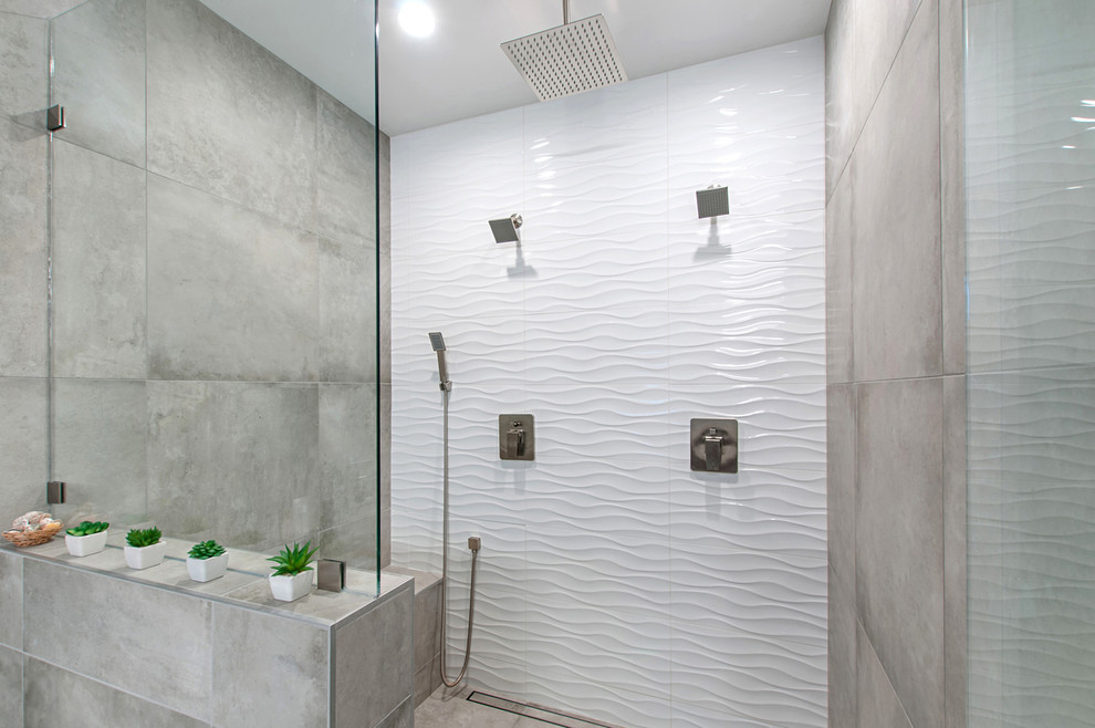 Photo of a large modern master bathroom in San Diego with flat-panel cabinets, medium wood cabinets, a freestanding tub, a double shower, gray tile, travertine, grey walls, cement tiles, a vessel sink, engineered quartz benchtops, grey floor and a hinged shower door.