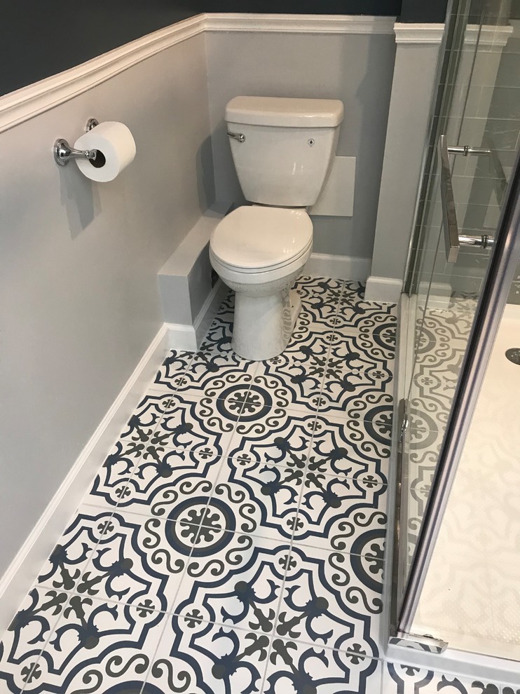 Mid-sized contemporary master bathroom in Baltimore with glass-front cabinets, white cabinets, an open shower, a two-piece toilet, gray tile, glass tile, blue walls, cement tiles, a vessel sink, quartzite benchtops, blue floor, a hinged shower door and white benchtops.