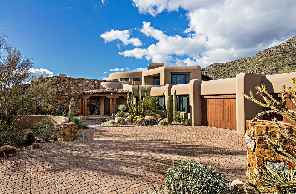 Inspiration for a two-storey brown house exterior in Phoenix with a flat roof.