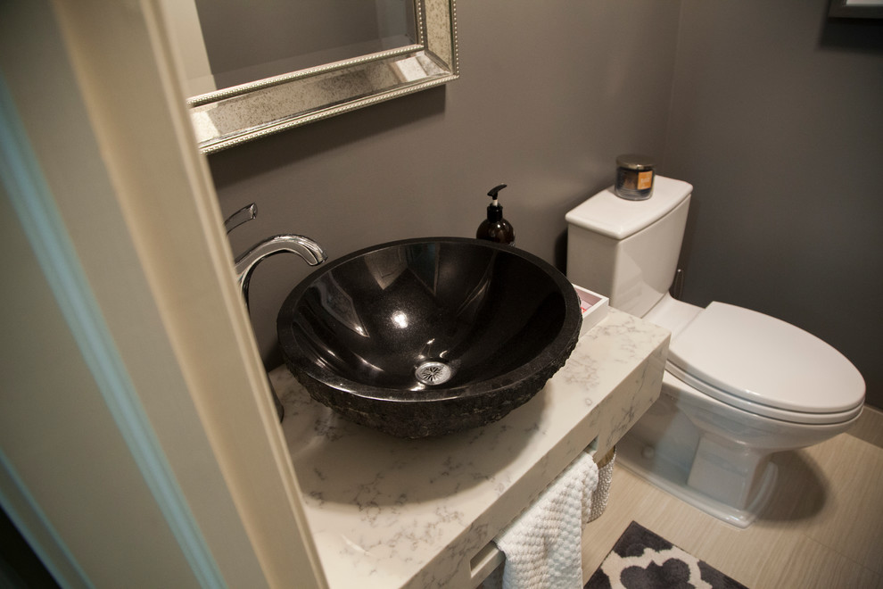 Bathroom - small transitional 3/4 beige tile and porcelain tile porcelain tile bathroom idea in Calgary with a two-piece toilet, gray walls, a vessel sink and quartz countertops
