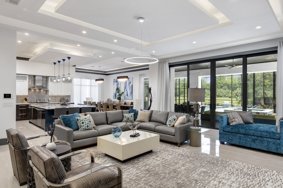Photo of a contemporary open concept living room in Orlando with white walls and grey floor.