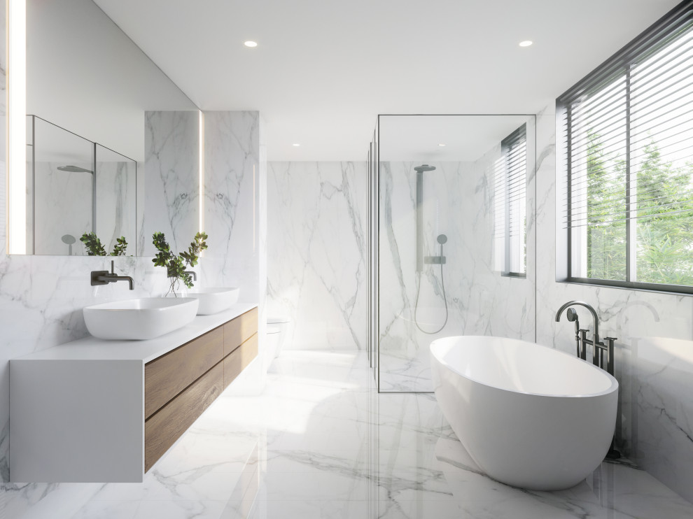 This is an example of a large contemporary master bathroom in New York with flat-panel cabinets, white cabinets, a freestanding tub, a curbless shower, multi-coloured tile, marble, marble floors, tile benchtops, a hinged shower door, yellow benchtops, an enclosed toilet, a double vanity and a floating vanity.