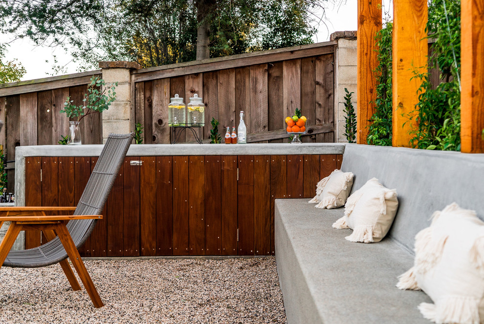 This is an example of a large contemporary full sun backyard landscaping in San Diego with decking.