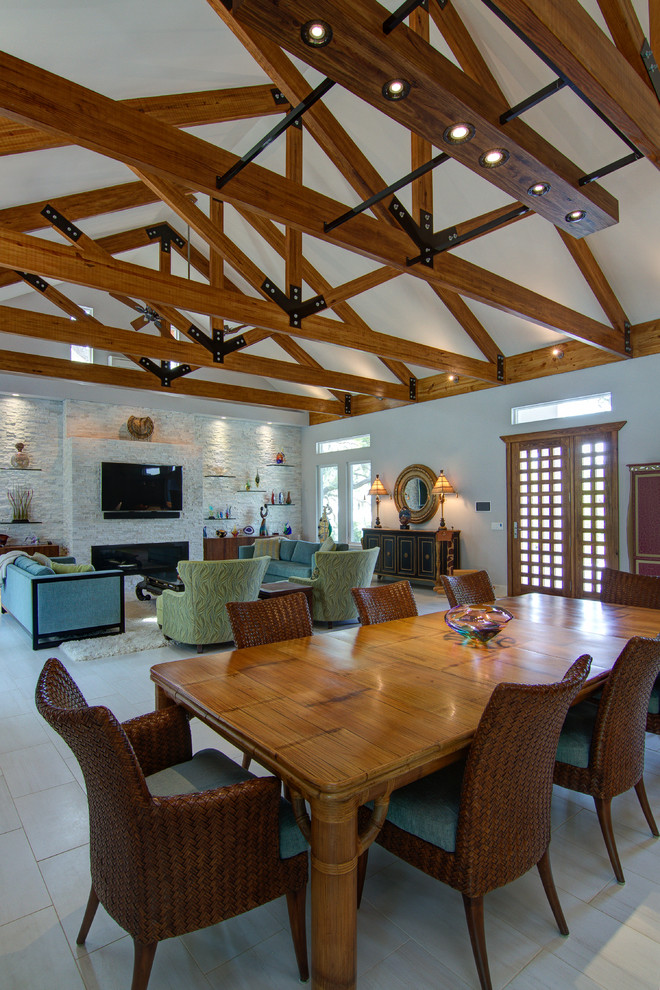 Photo of a large contemporary open plan dining in Tampa with porcelain floors, a stone fireplace surround and white walls.