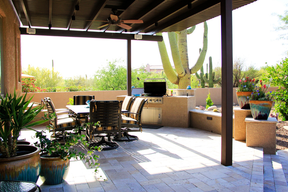 Inspiration for a large mediterranean backyard patio in Phoenix with a fire feature, tile and a roof extension.