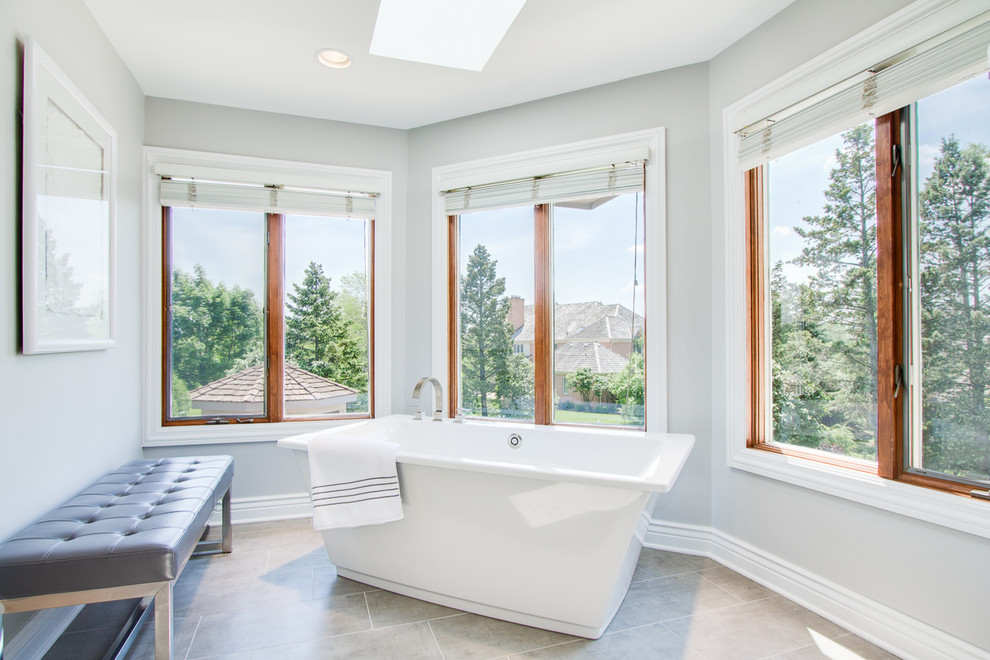 Huge transitional master brown tile and porcelain tile porcelain tile freestanding bathtub photo in Chicago with gray walls, shaker cabinets, white cabinets, an undermount sink and granite countertops