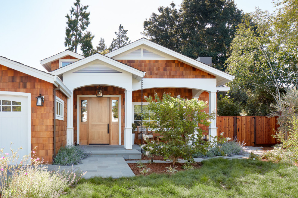 Inspiration for a large transitional one-story wood and shingle exterior home remodel in San Francisco with a shingle roof and a black roof