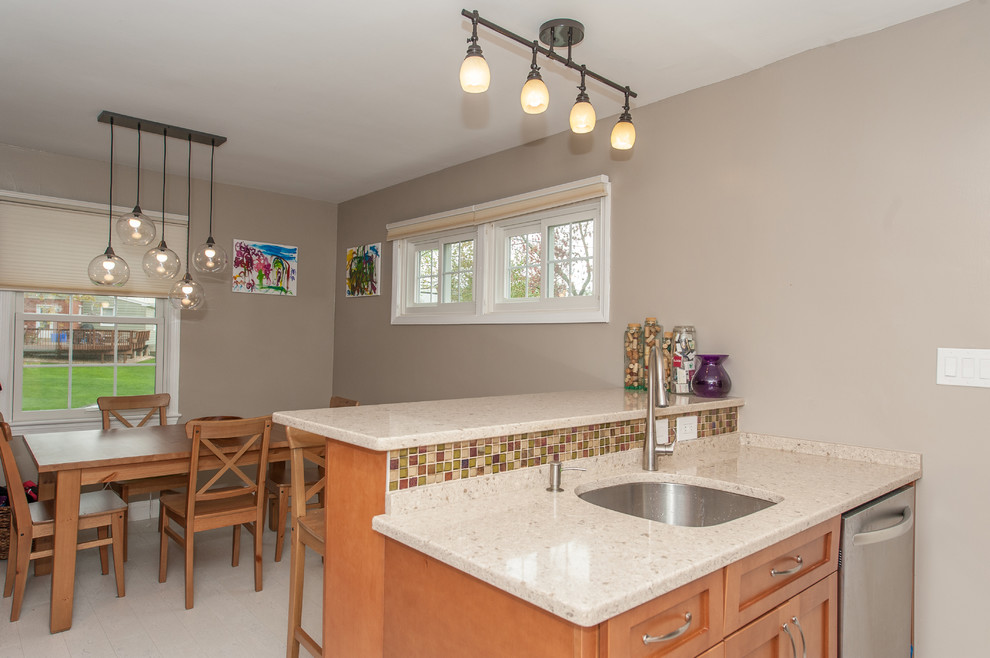 Eat-in kitchen - large transitional galley cork floor eat-in kitchen idea in DC Metro with an undermount sink, shaker cabinets, brown cabinets, quartz countertops, multicolored backsplash, glass tile backsplash and stainless steel appliances