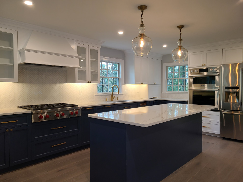 Idéer för att renovera ett stort funkis vit vitt kök, med en undermonterad diskho, skåp i shakerstil, blå skåp, bänkskiva i kvarts, vitt stänkskydd, stänkskydd i marmor, rostfria vitvaror, mellanmörkt trägolv, en köksö och brunt golv