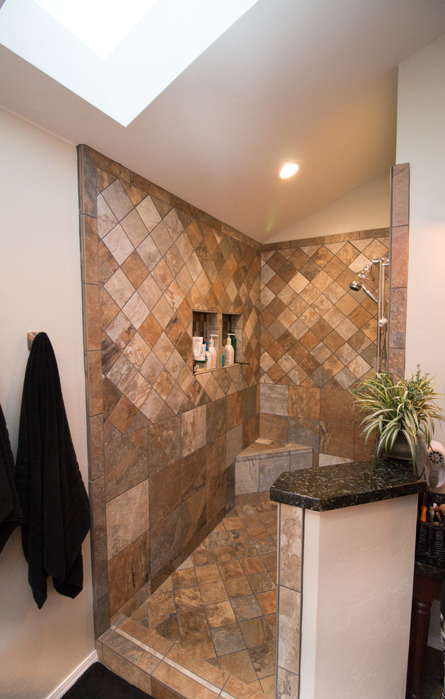 Photo of a large midcentury master bathroom in Other with flat-panel cabinets, medium wood cabinets, a corner tub, an open shower, a one-piece toilet, multi-coloured tile, porcelain tile, beige walls, slate floors, an undermount sink and granite benchtops.