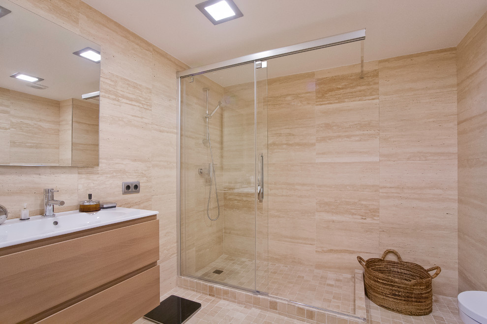 Photo of a mid-sized contemporary master bathroom in Barcelona with flat-panel cabinets, medium wood cabinets, beige tile, stone slab, an open shower, a wall-mount toilet, beige walls and travertine floors.