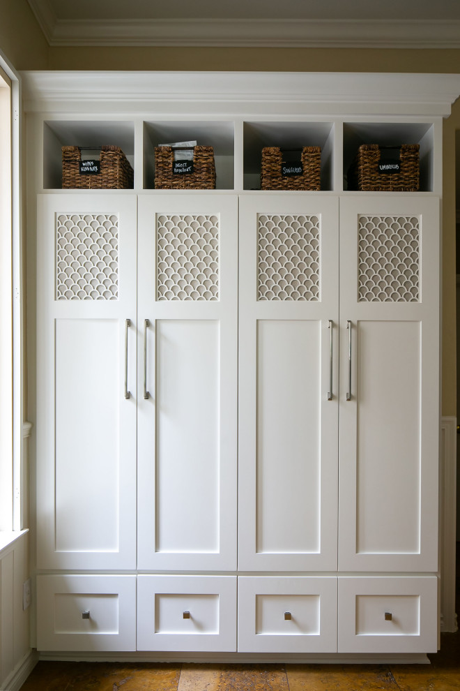 This is an example of a transitional mudroom in Orange County with beige walls, travertine floors and beige floor.