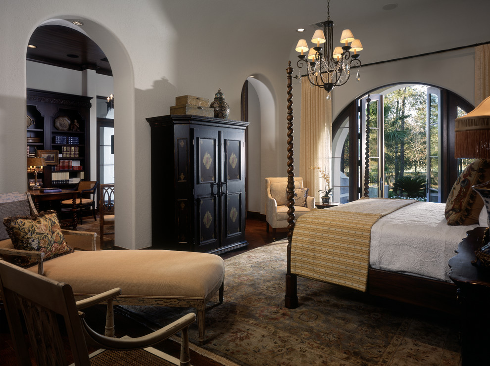 Large eclectic master bedroom in Houston with white walls.